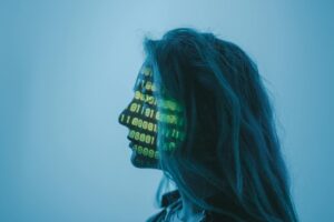 Silhouette of a woman with binary code projected on her face in a digital concept setting.