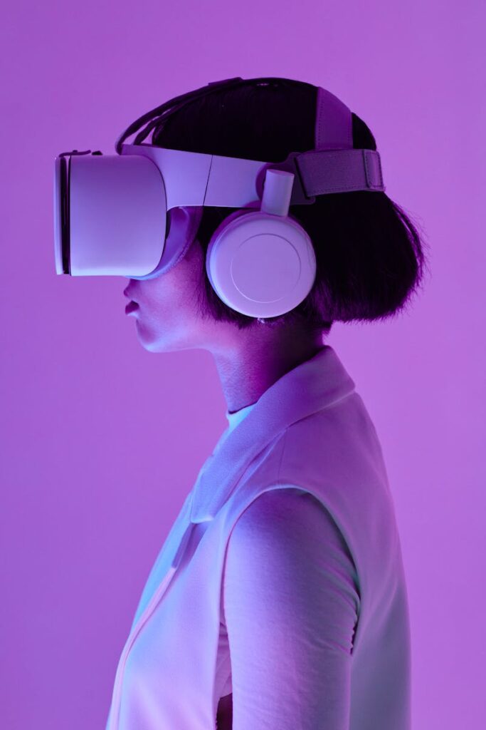 Services 7 Side profile of a woman wearing vr goggles in a studio with purple lighting, embodying future tech.