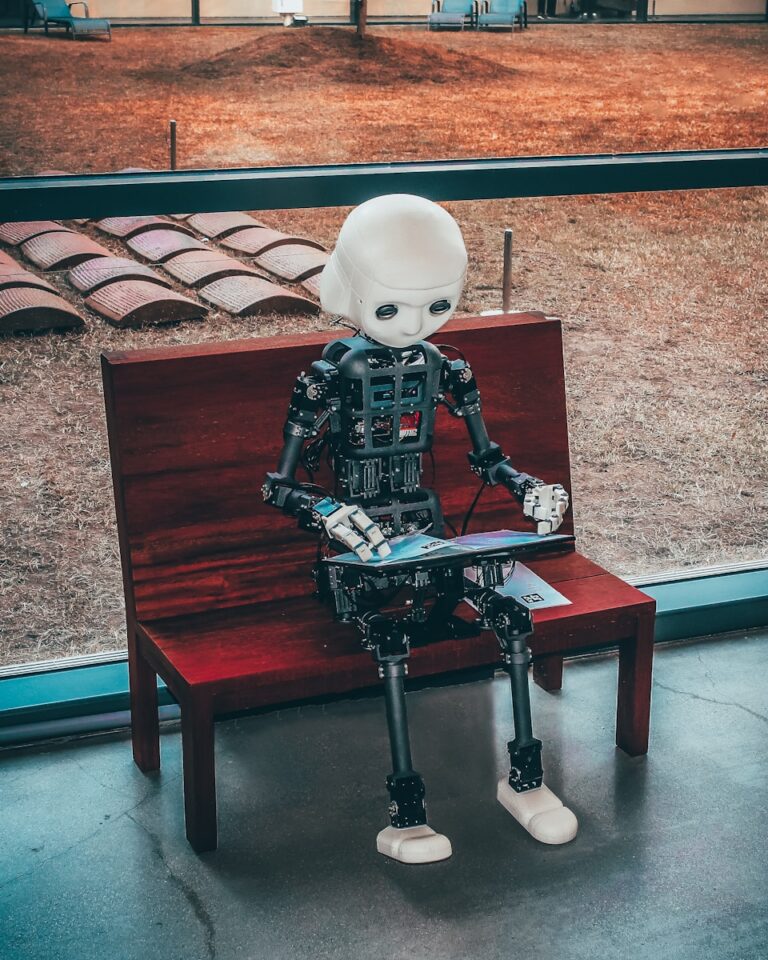 Black and white robot toy on red wooden table